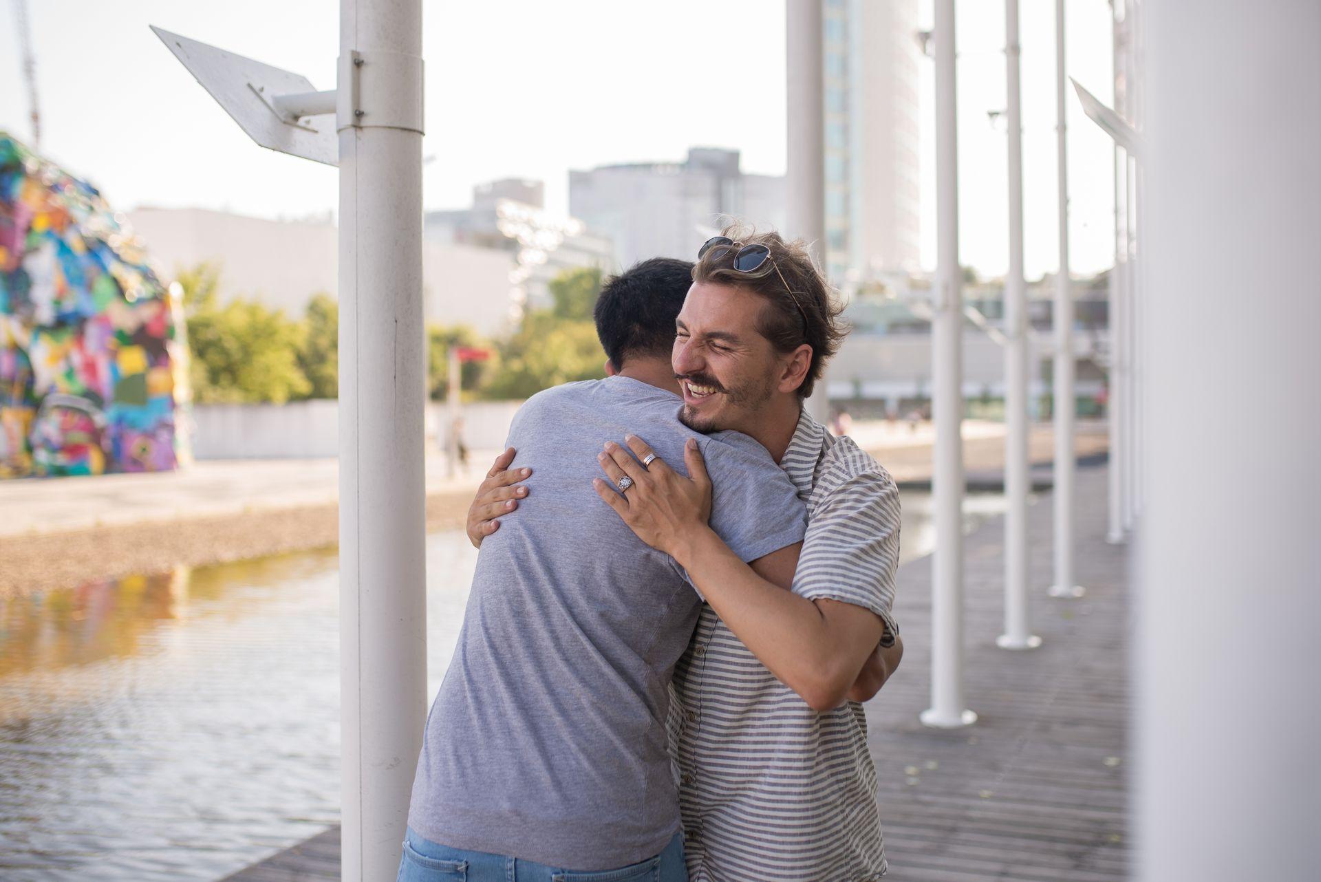 Two friends arriving from different directions meet outside a railway station